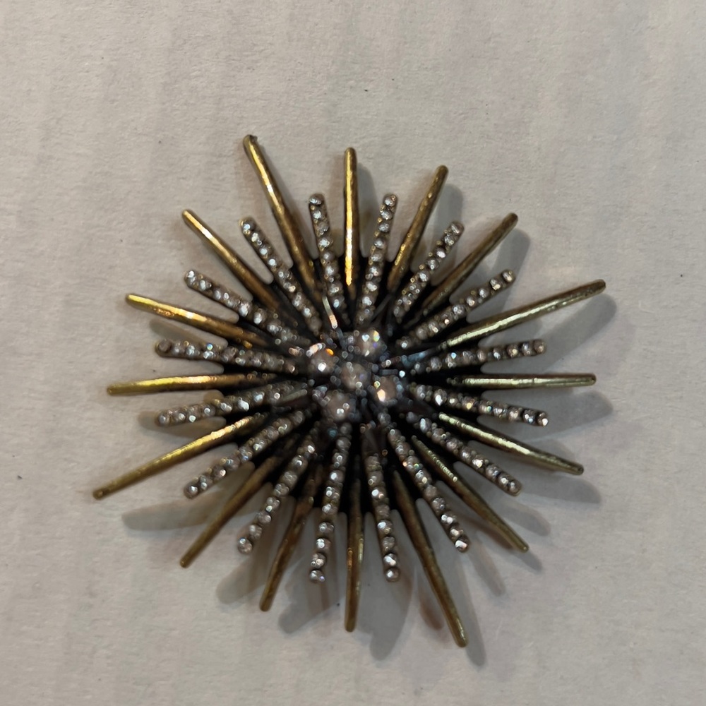 Vera Wang Star burst brooch pin. Gold tone with white rhinestones.